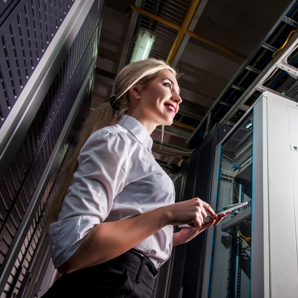 Smiling Female IT Tech in Server Room